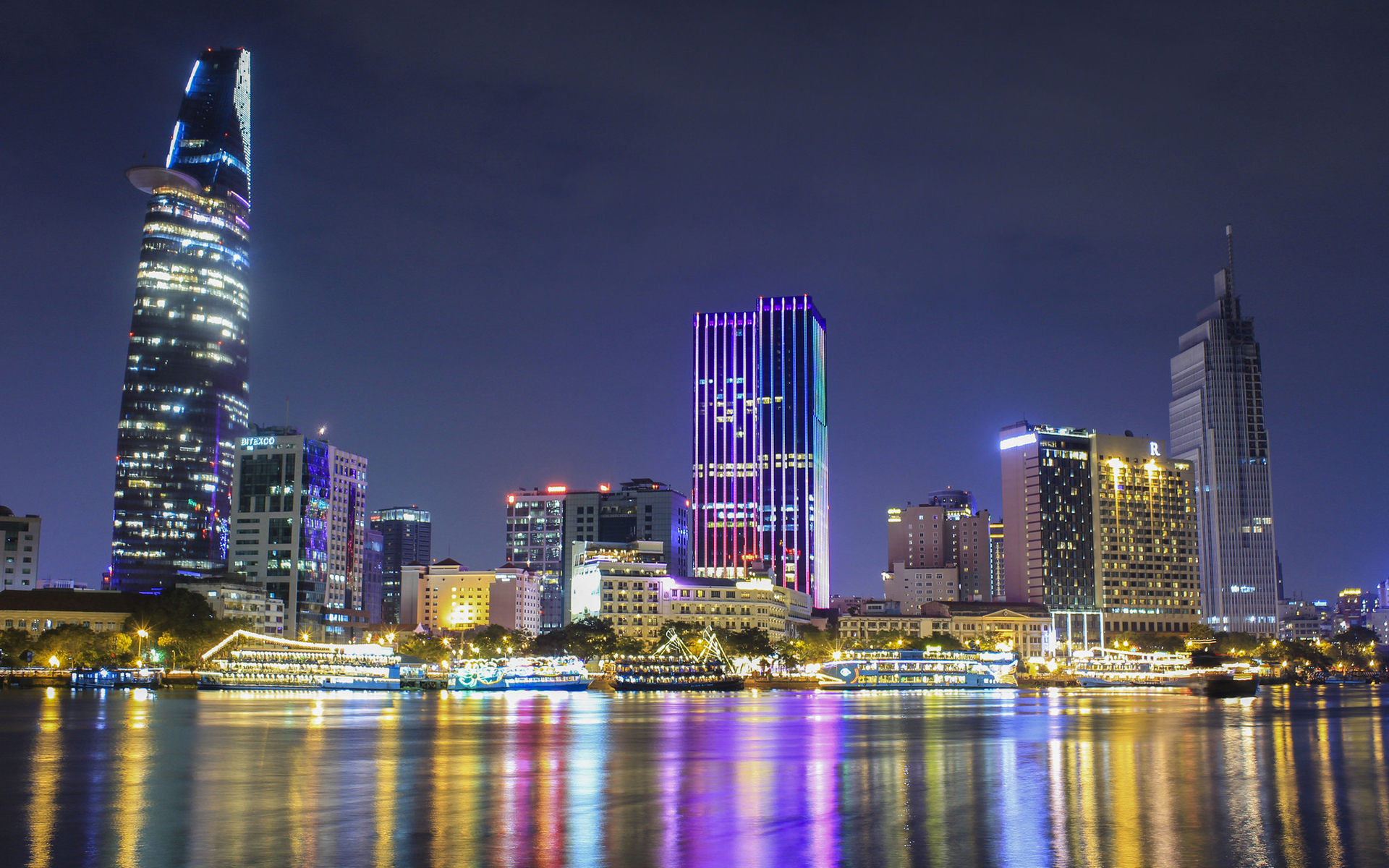 Ho Chi Minh City skyline at night, representing financial growth and advisory